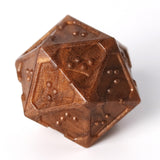 Closeup of acrylic braille d20 in molten bronze